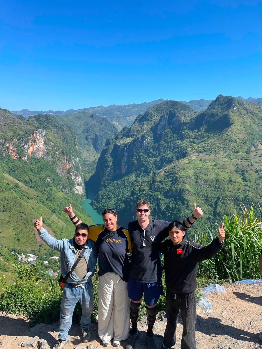 Guests-with-motorbikes-in-front-of-golden-rice-terraces-on-the-Ha-Giang-Loop